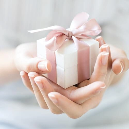 Woman holding a boxed gift